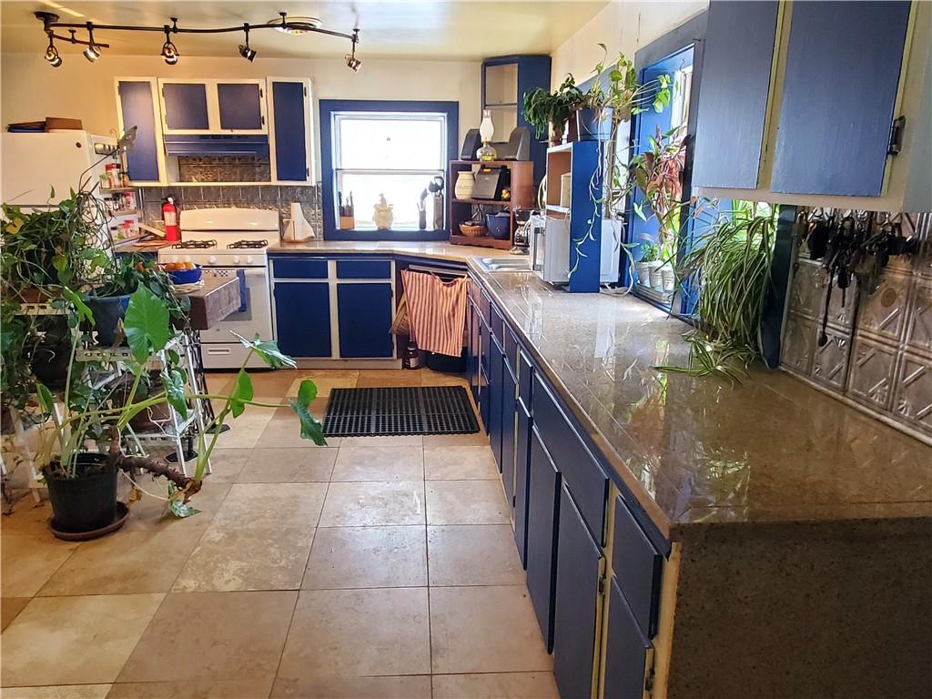 392 Beaver Ridge Road Jasper, GA 30143 - Photo 16 of 55 a kitchen with stainless steel appliances granite countertop sink a microwave and cabinets