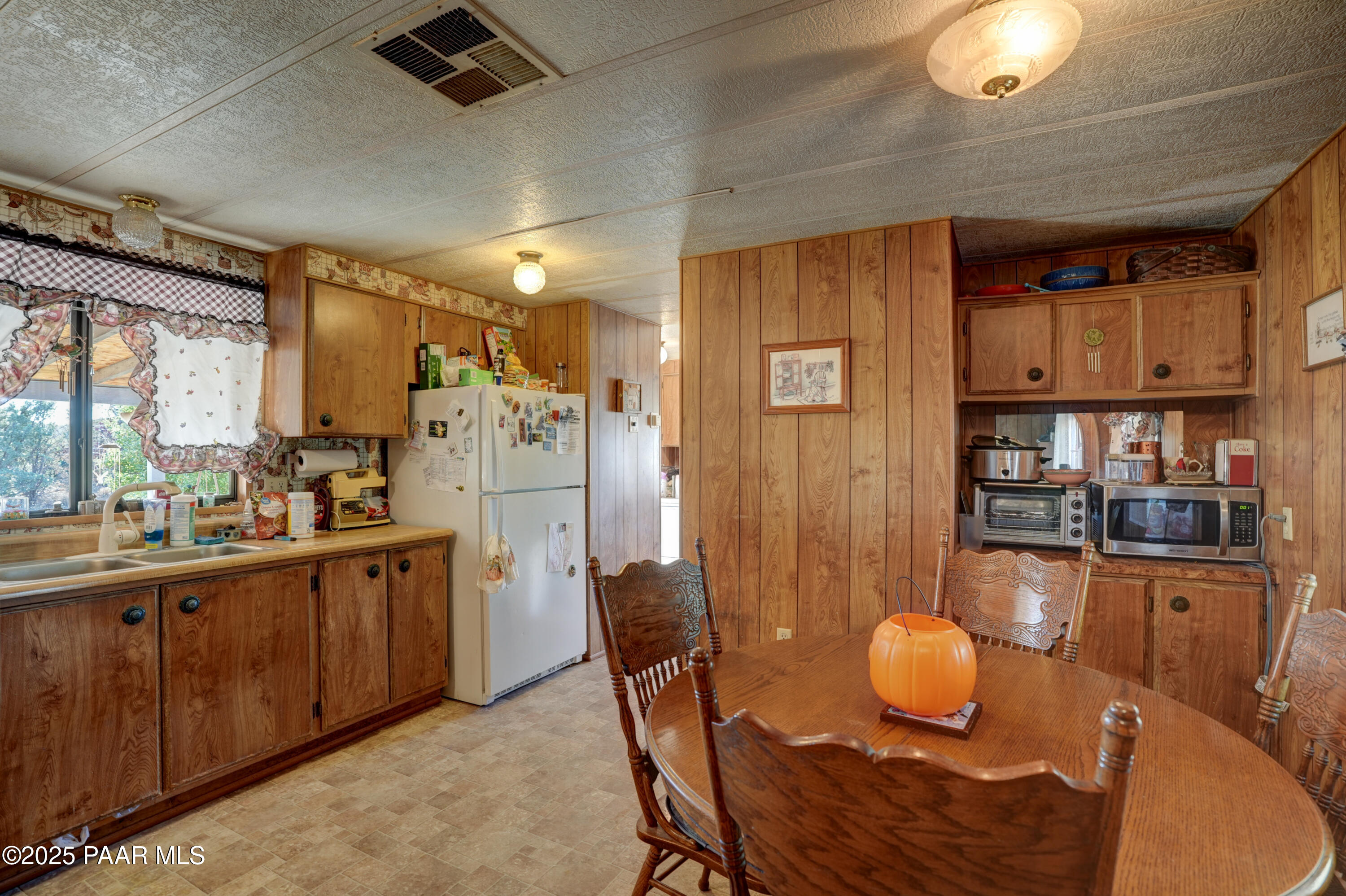 24025 North State Route 89 Paulden, AZ 86334 - Photo 11 of 29 a kitchen with stainless steel appliances wooden floors dining table and chairs