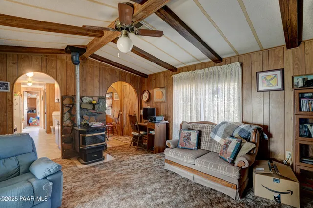 a view of a lake with a table and chairs under an umbrella