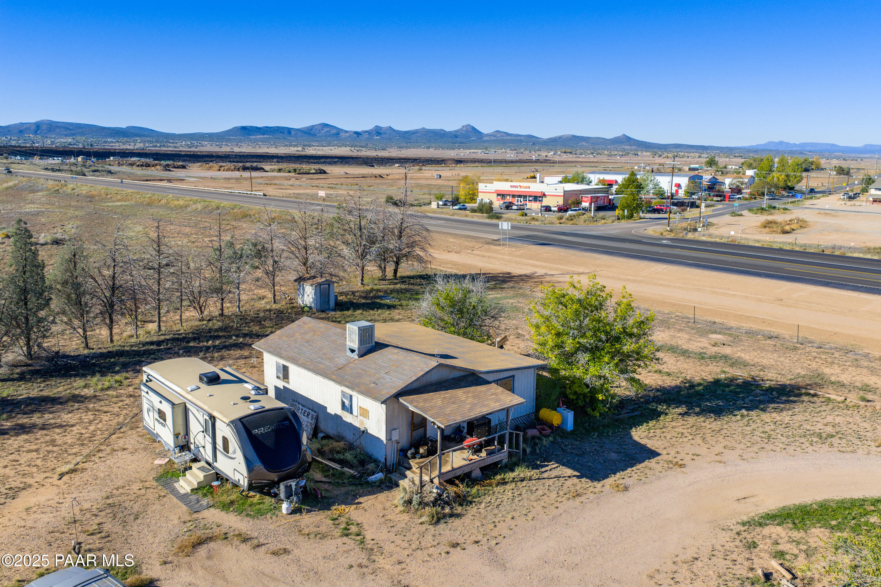 24025 North State Route 89 Paulden, AZ 86334 - Photo 18 of 29 a view of a lake with a table and chairs under an umbrella