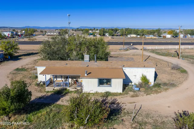 an aerial view of a house with a yard lake and outdoor seating