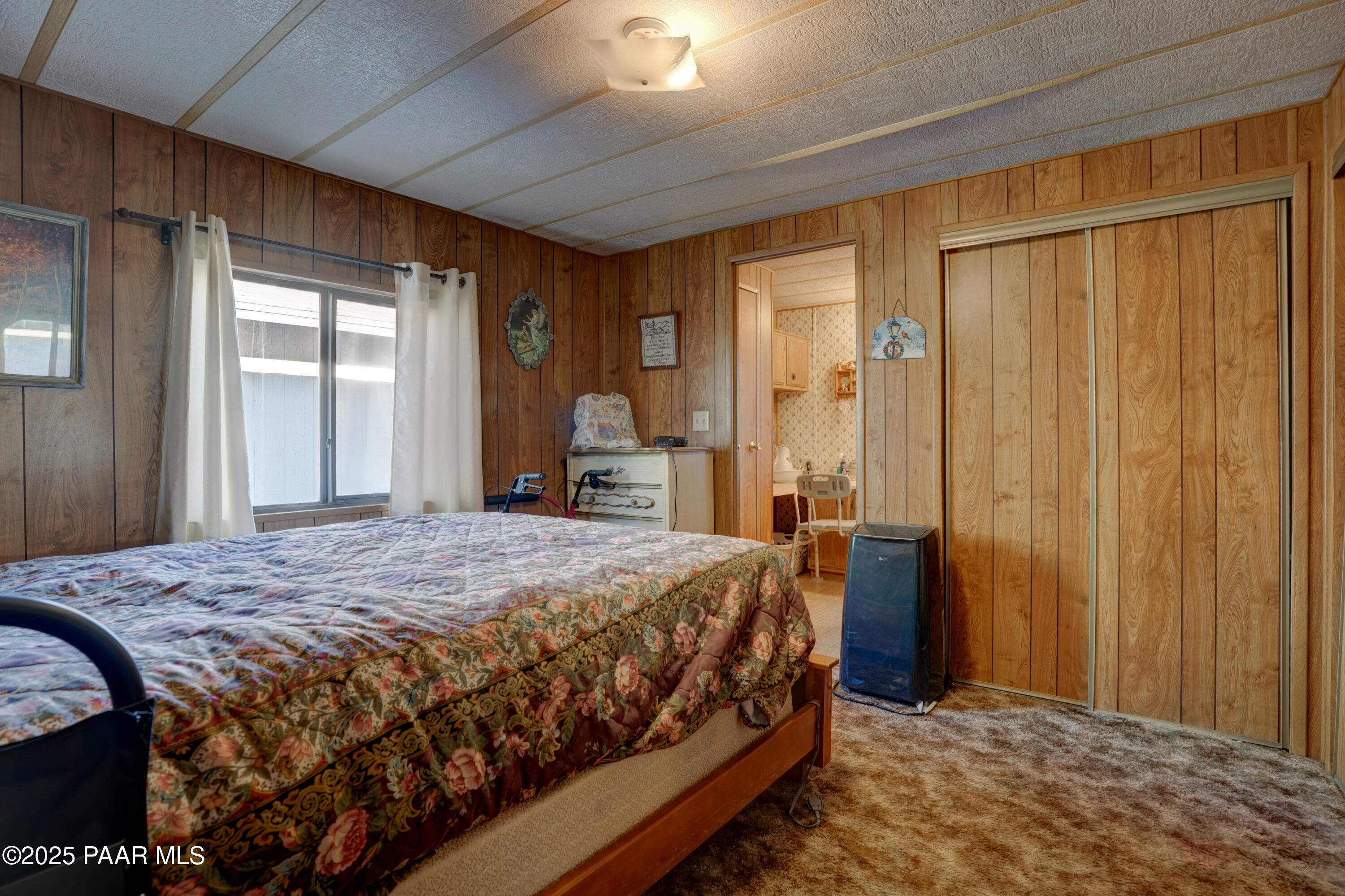 24025 North State Route 89 Paulden, AZ 86334 - Photo 6 of 29 a bedroom with a bed table and a large window