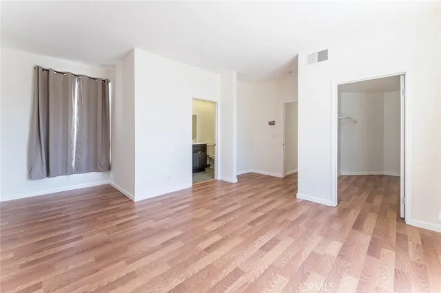 a view of wooden floor and windows in a room