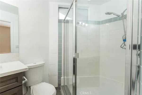 a bathroom with a shower a toilet and sink