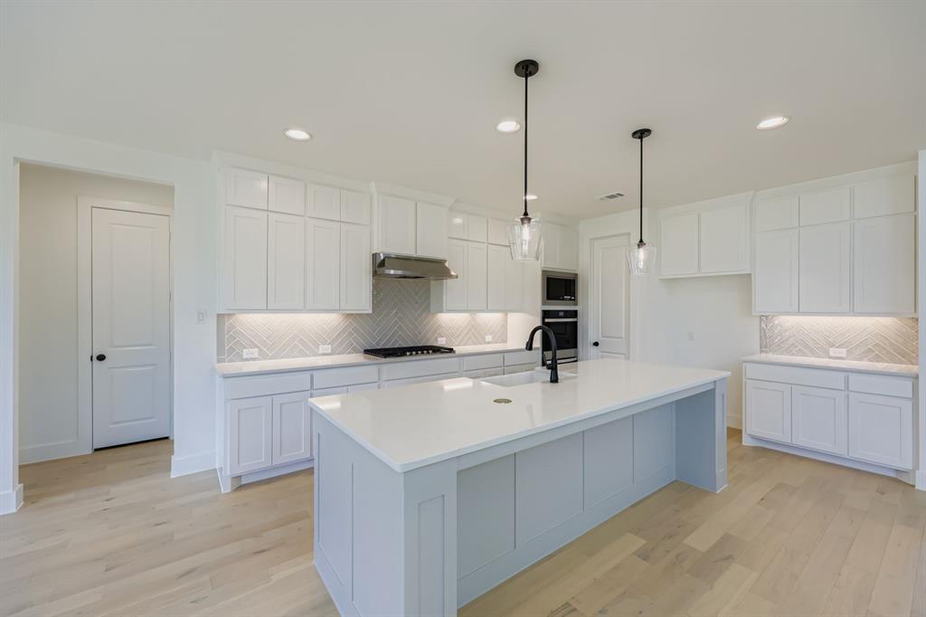 1841 Pk Vista Way Midlothian, TX 76065 - Photo 6 of 28 a kitchen with a sink a stove and a wooden floors