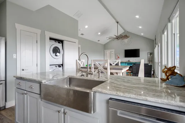 a kitchen with kitchen island a sink and a stove with wooden floor