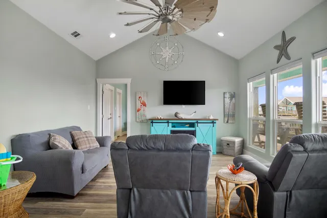 a living room with furniture and a chandelier