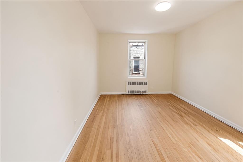 6801 Shore Road, Unit 4J Brooklyn, NY 11220 - Photo 11 of 15 an empty room with wooden floor and windows