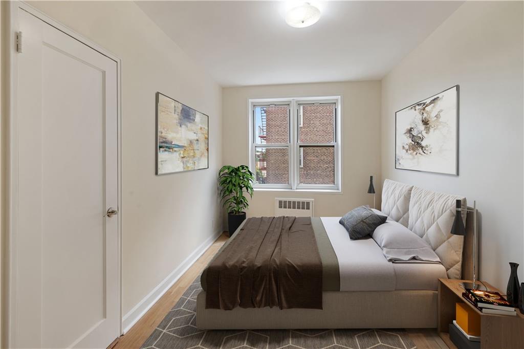 6801 Shore Road, Unit 4J Brooklyn, NY 11220 - Photo 13 of 15 a bedroom with a bed and wooden floor
