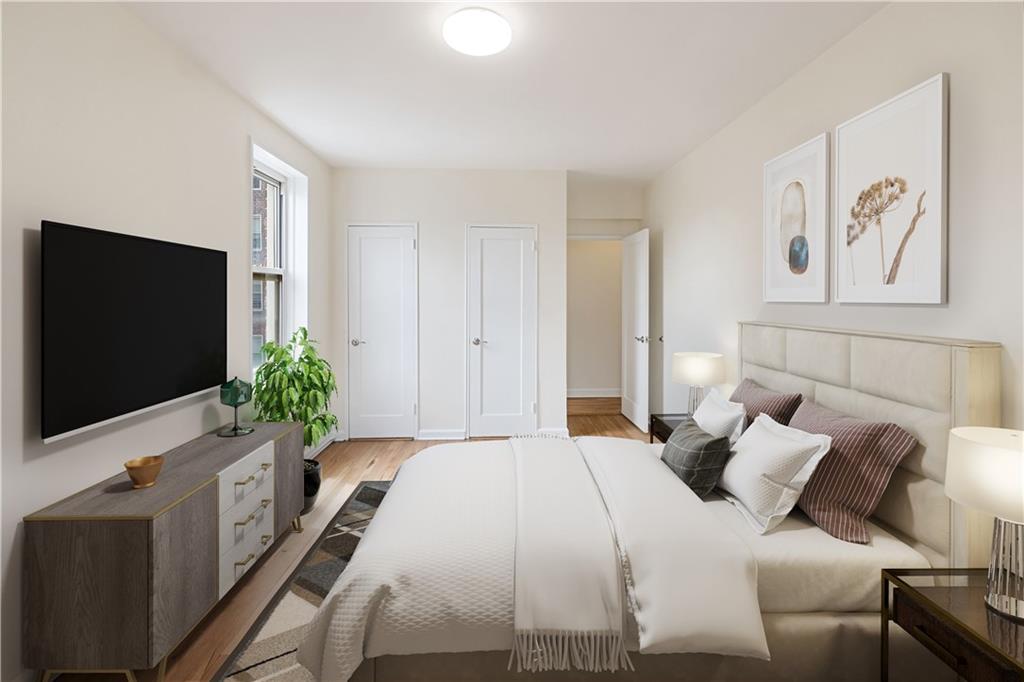 6801 Shore Road, Unit 4J Brooklyn, NY 11220 - Photo 9 of 15 a bedroom with a bed and a flat screen tv