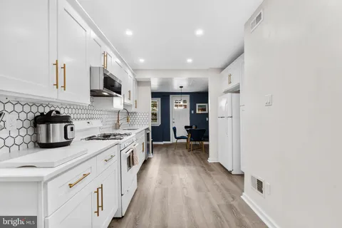 a kitchen with stainless steel appliances granite countertop lots of counter top space and cabinets