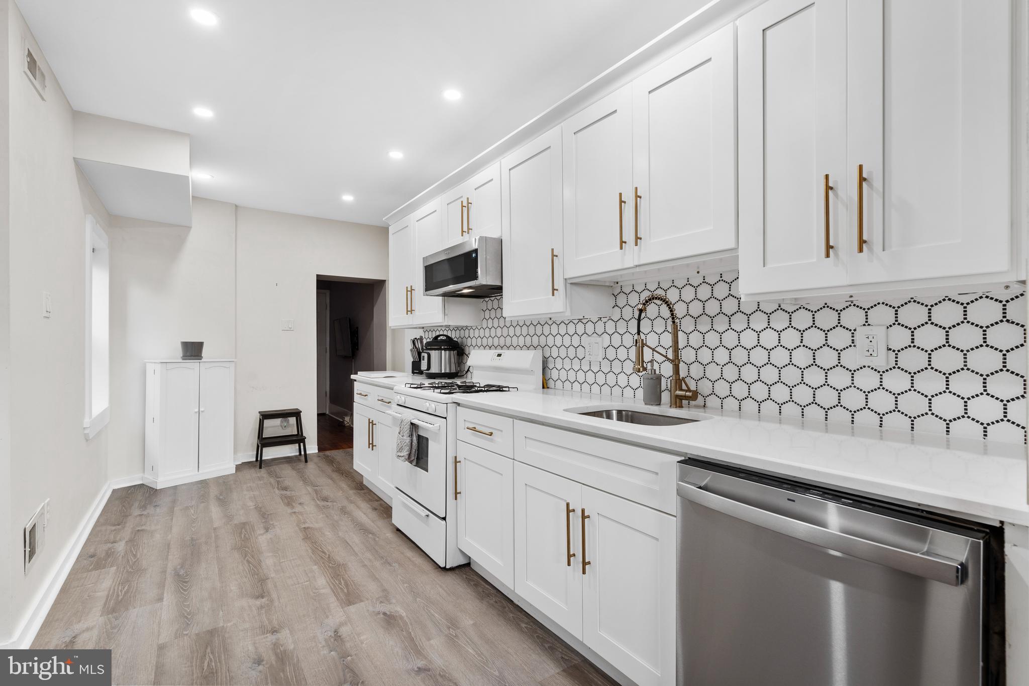 2564 Kern Street Philadelphia, PA 19125 - Photo 11 of 35 a kitchen with sink cabinets and window