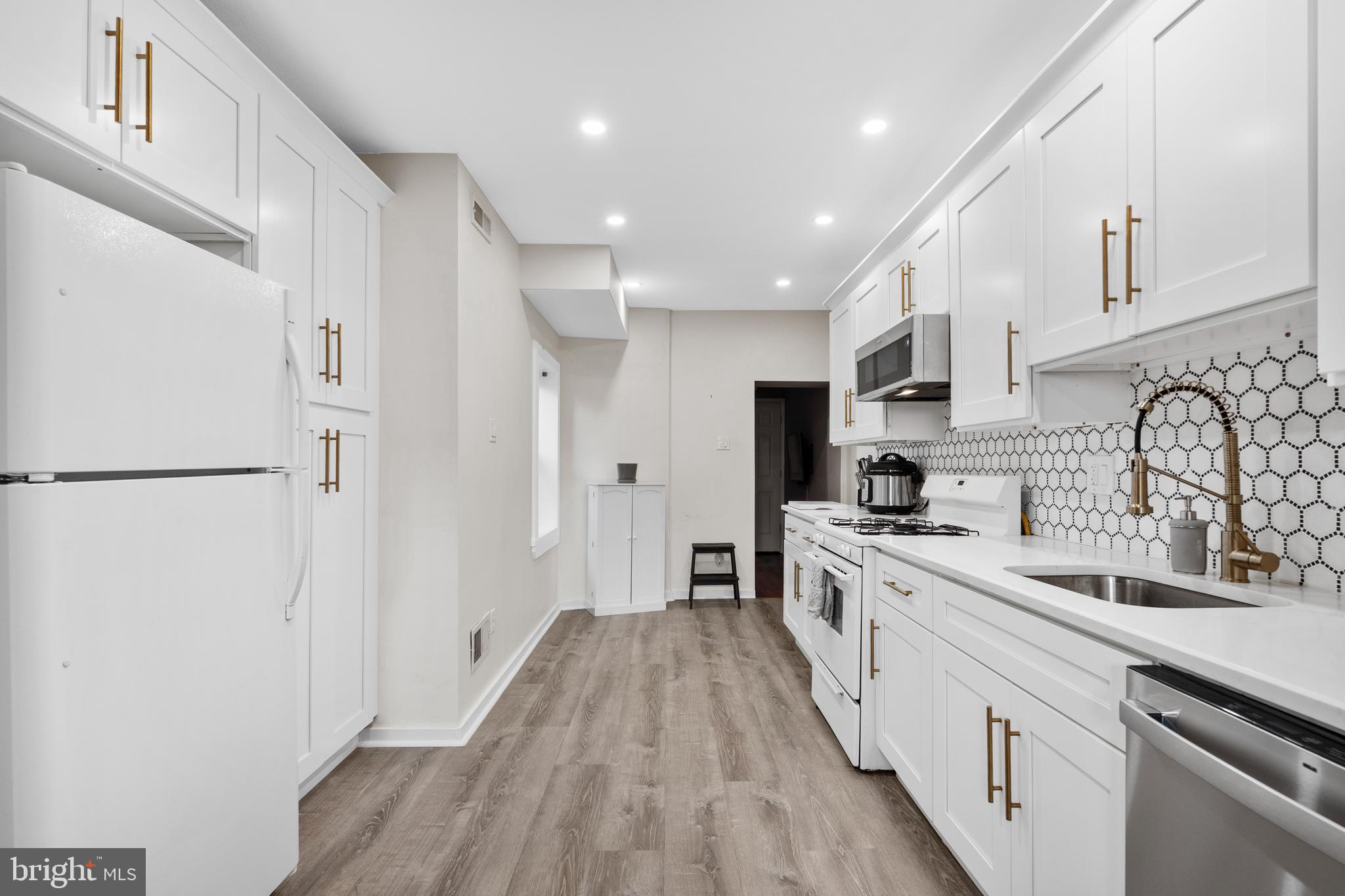 2564 Kern Street Philadelphia, PA 19125 - Photo 12 of 35 a large kitchen with a lot of counter space and wooden floor