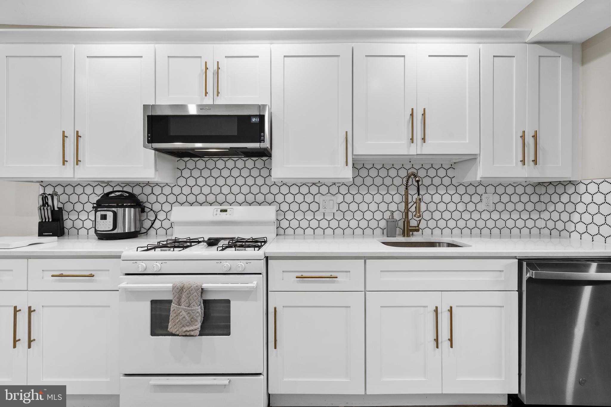 2564 Kern Street Philadelphia, PA 19125 - Photo 13 of 35 a kitchen with white cabinets and appliances