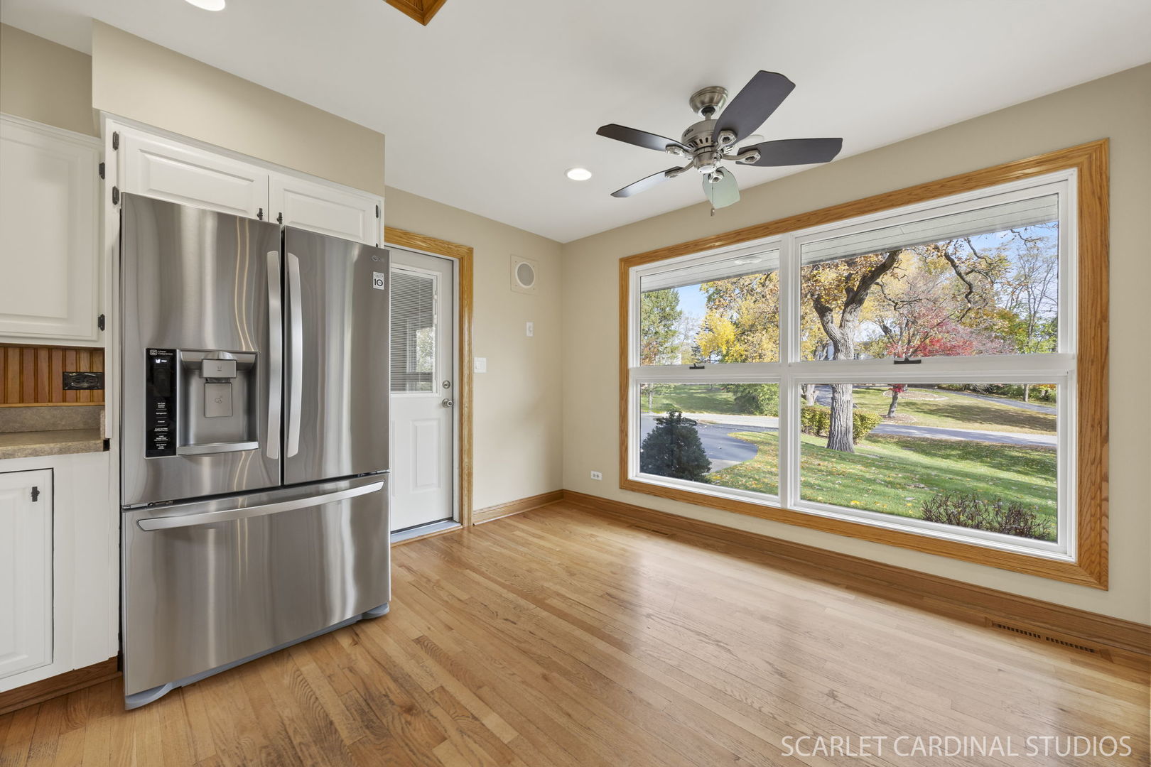 1007 Beau Brummel Drive Sleepy Hollow, IL 60118 - Photo 9 of 35 a view of a livingroom with wooden floor a ceiling fan and a window