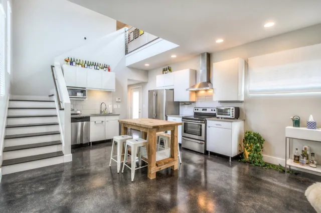 a kitchen with a sink cabinets and wooden floor