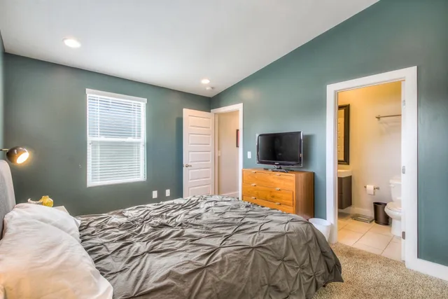 a bedroom with a bed and a flat screen tv
