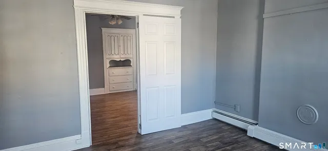 a view of a hallway with wooden floor