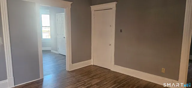 a view of a hallway with wooden floor