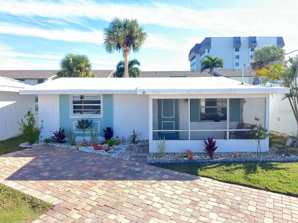 6020 Midnight Pass Road, Unit 45 Sarasota, FL 34242 - Photo 13 of 16 a front view of a house with garden