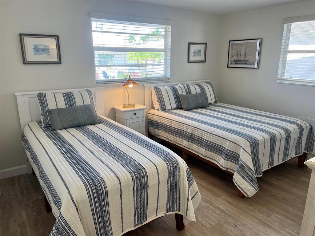 6020 Midnight Pass Road, Unit 45 Sarasota, FL 34242 - Photo 15 of 16 a bedroom with two beds and a couch