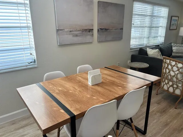 a dining room with furniture and window