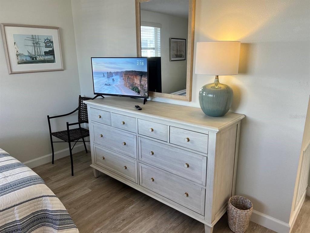 6020 Midnight Pass Road, Unit 45 Sarasota, FL 34242 - Photo 3 of 16 a living room with furniture and a flat screen tv