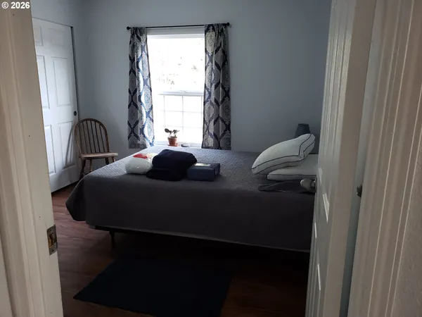 a bedroom with a bed window and a table