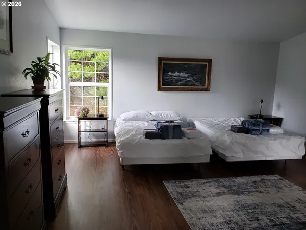 a living room with furniture window and wooden floor