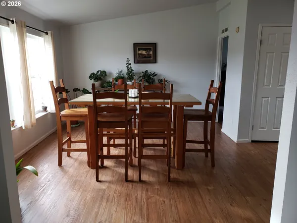 a view of a dining room with furniture and wooden floor