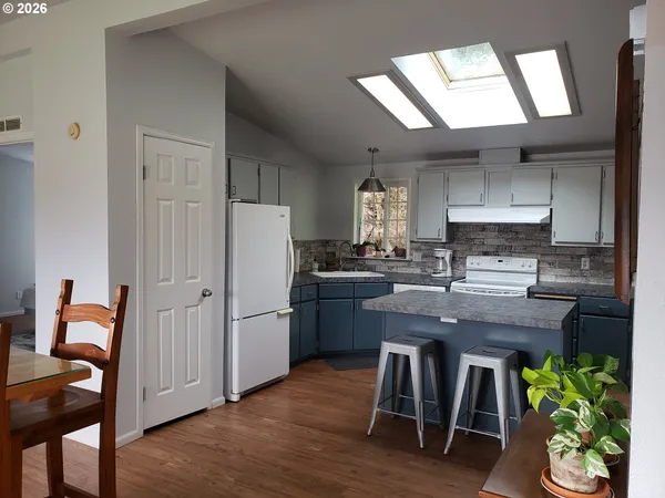 a kitchen with furniture and a wooden floor