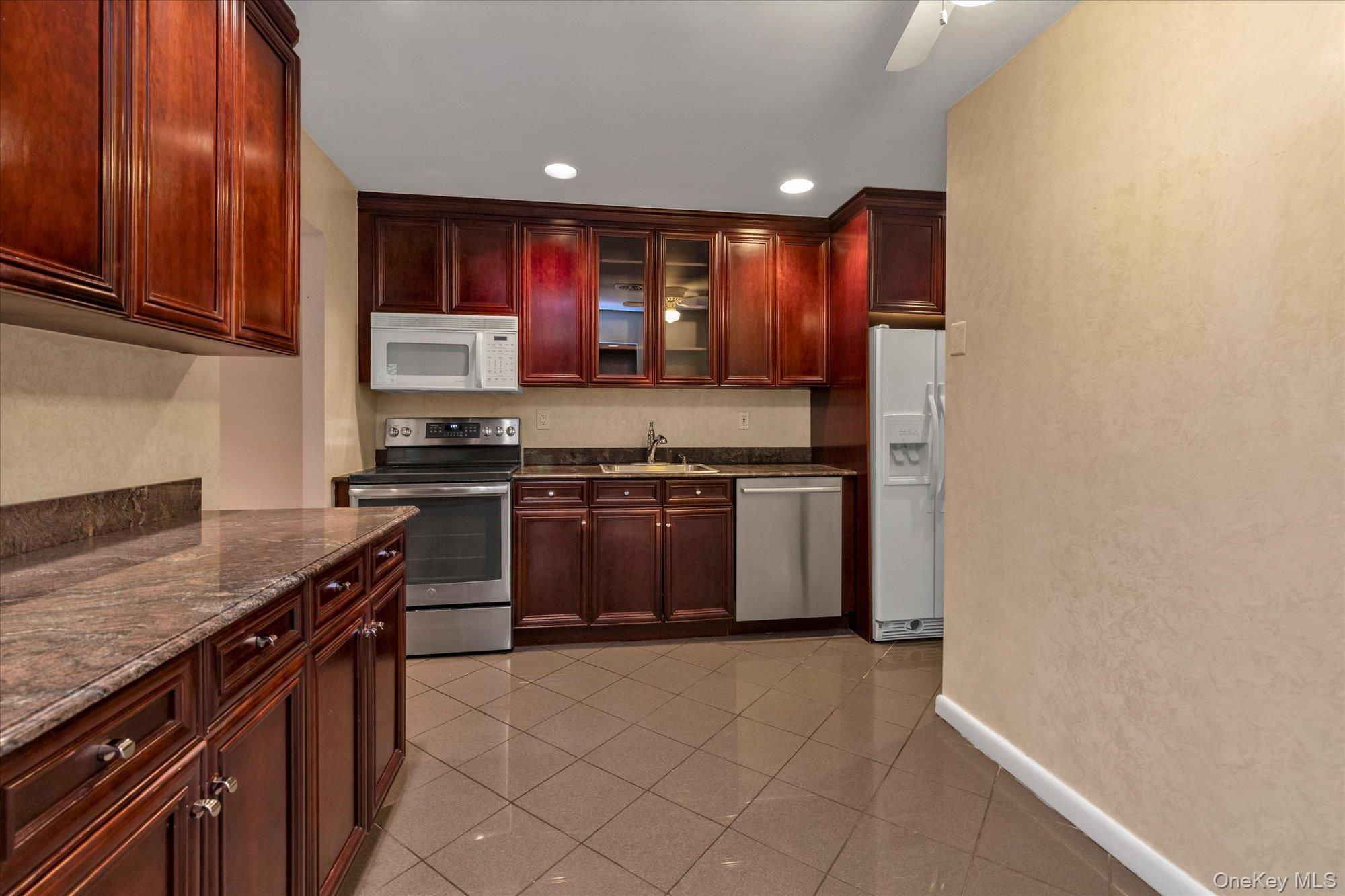 41 Spring Hollow Road Roslyn, NY 11576 - Photo 8 of 27 a kitchen with stainless steel appliances granite countertop a stove a sink and a refrigerator