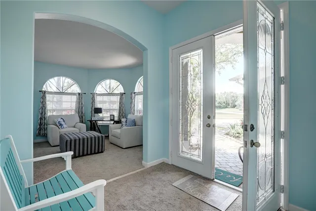 a view of a dining room with furniture and chandelier