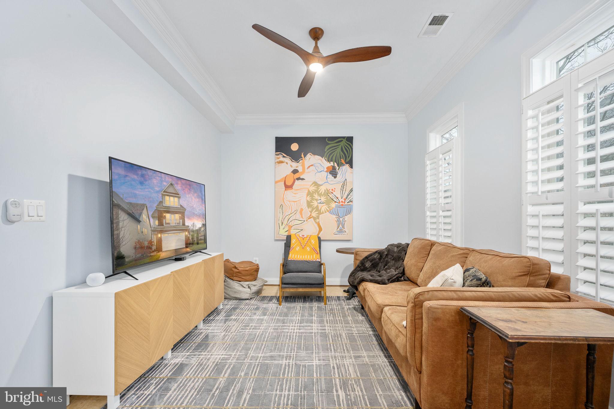 6044 Masondale Road Alexandria, VA 22315 - Photo 15 of 64 a living room with furniture and a flat screen tv
