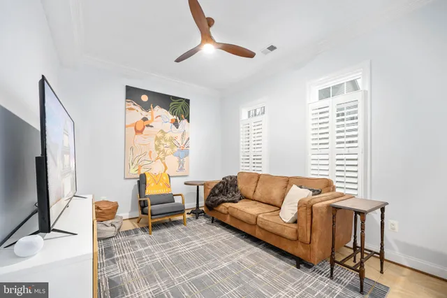 a kitchen with stainless steel appliances granite countertop wooden cabinets a sink dishwasher a stove and a refrigerator with wooden floor