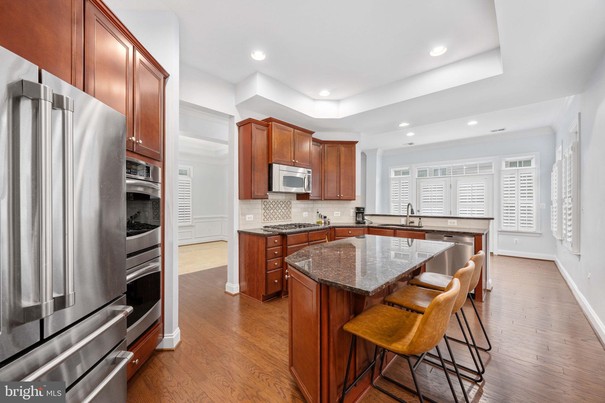 6044 Masondale Road Alexandria, VA 22315 - Photo 23 of 64 a kitchen with stainless steel appliances granite countertop a refrigerator and a stove top oven