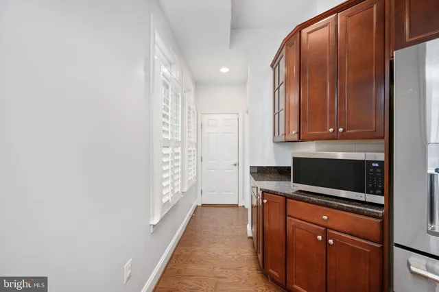 a bathroom with a toilet a sink and a mirror