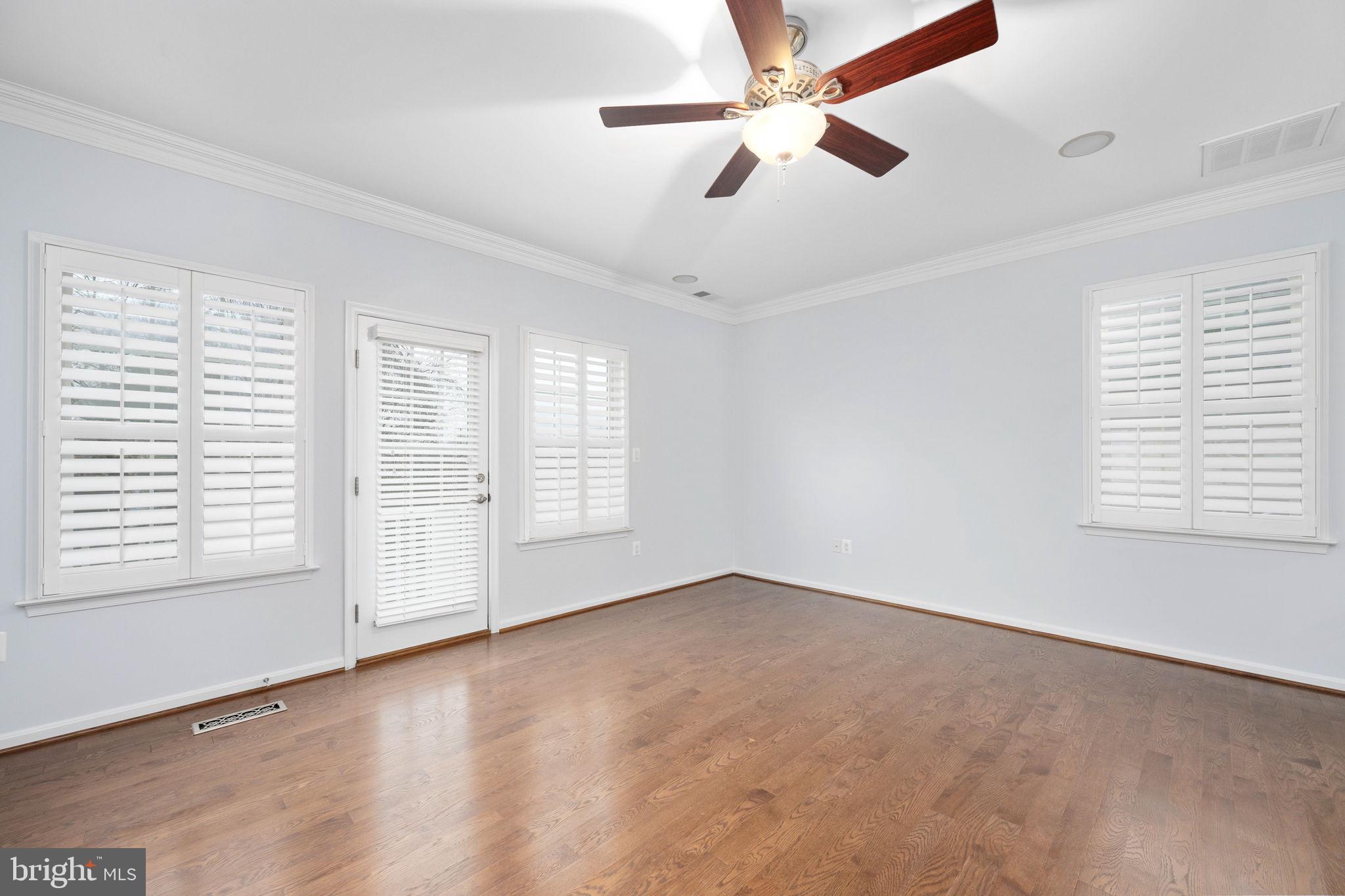 6044 Masondale Road Alexandria, VA 22315 - Photo 30 of 64 an empty room with chandelier fan and windows