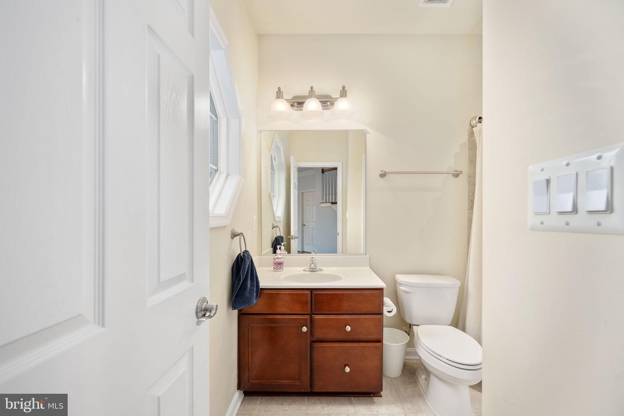 6044 Masondale Road Alexandria, VA 22315 - Photo 35 of 64 a bathroom with a toilet a sink and a mirror