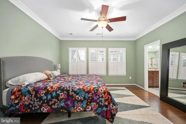 a bedroom with a bed and ceiling fan