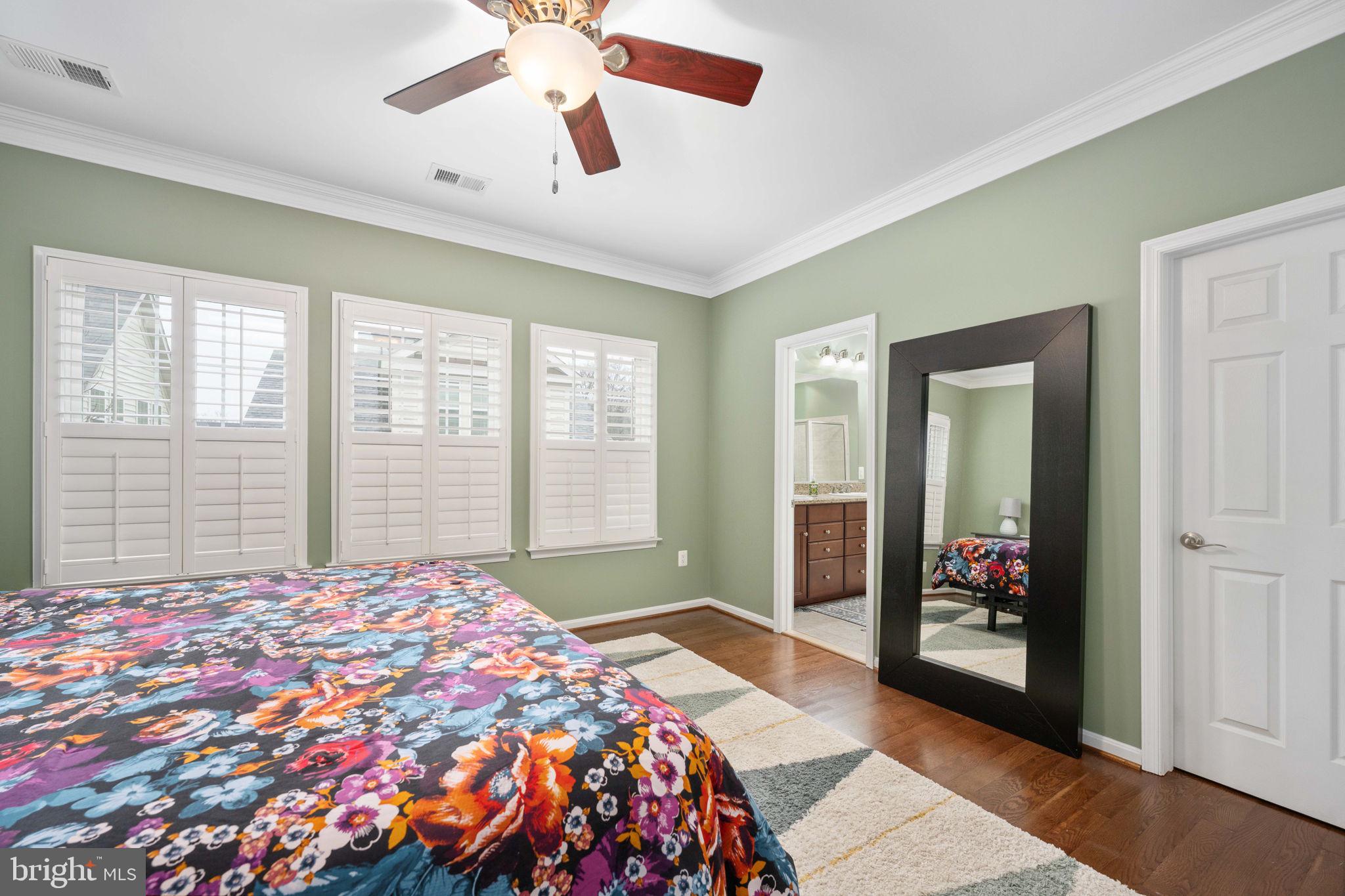 6044 Masondale Road Alexandria, VA 22315 - Photo 40 of 64 a bedroom with a large bed and a chandelier