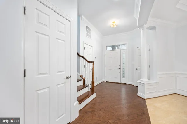 a view of staircase with wooden floor and white walls