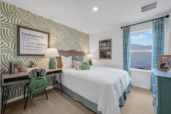 a bedroom with a bed and a window