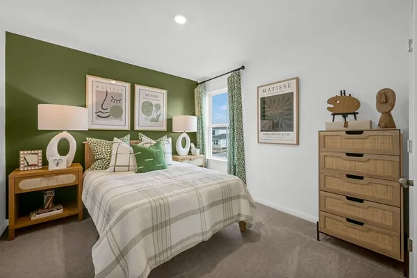 a bedroom with a bed and a dresser