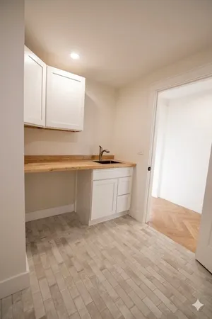 wooden floor fireplace and windows in an empty room