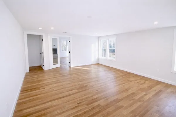 a view of an empty room and wooden floor