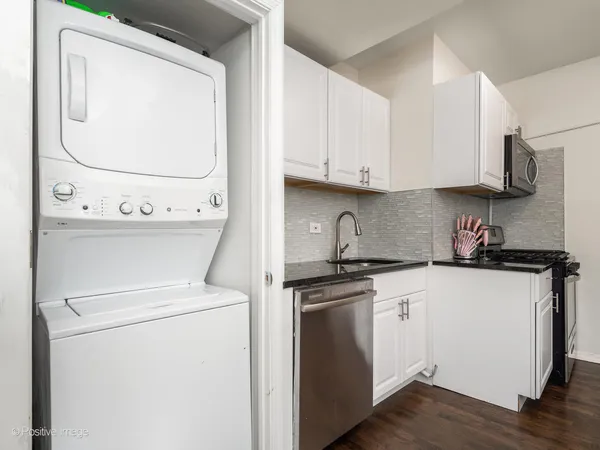 a kitchen with stainless steel appliances granite countertop a sink and a stove