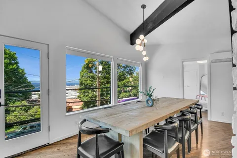 a view of a dining room with furniture window and wooden floor