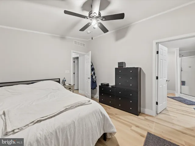 a bedroom with a bed and a dresser