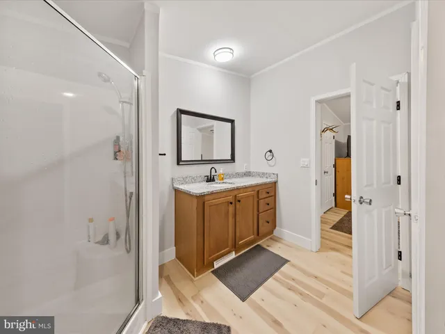 a spacious bathroom with a shower sink and mirror